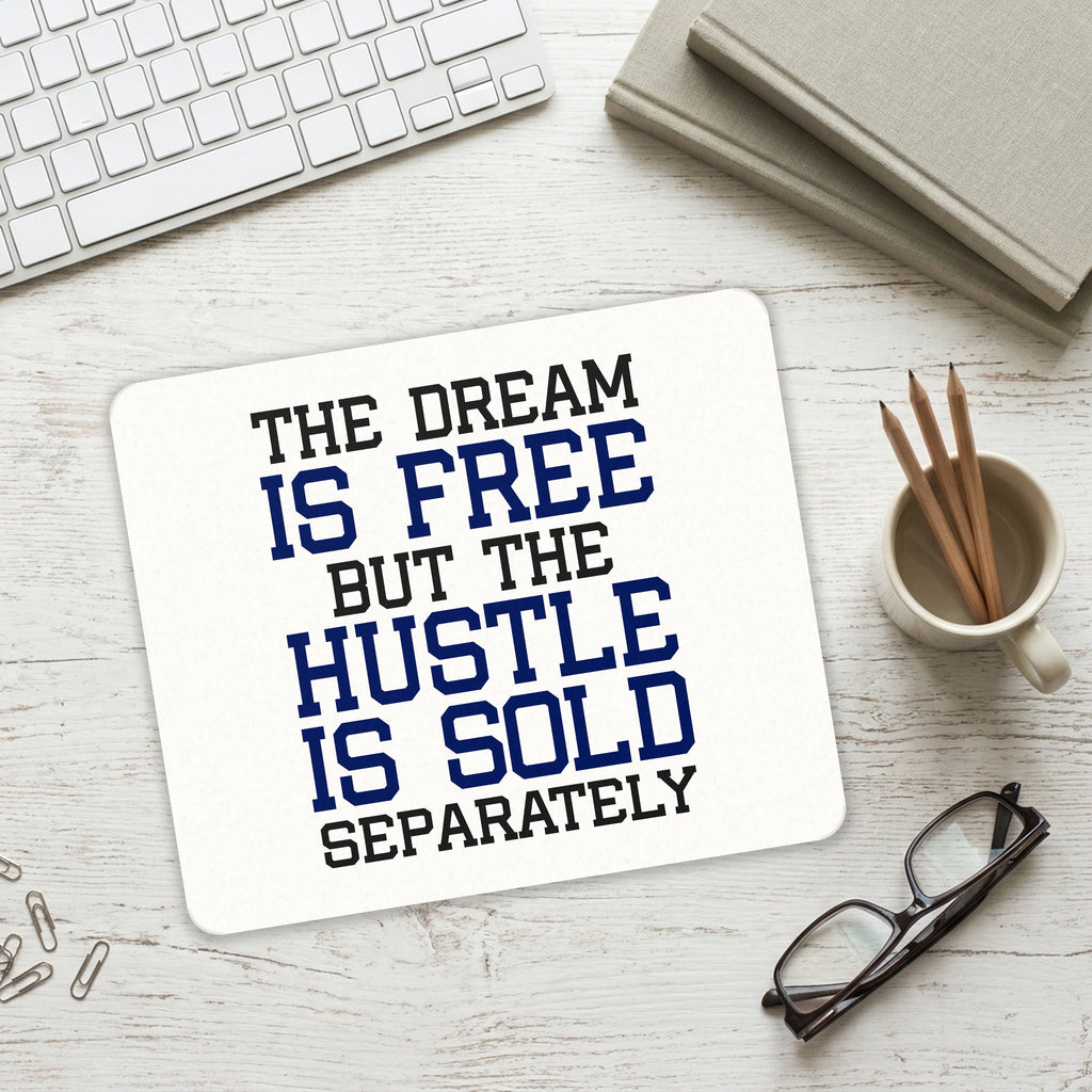 The Dream is Free Hustle Sold Separately mouse pad on a desk with a keyboard