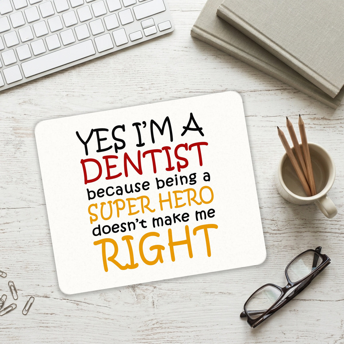 Yes I'm a Dentist Super Hero mouse pad on a desk with a keyboard