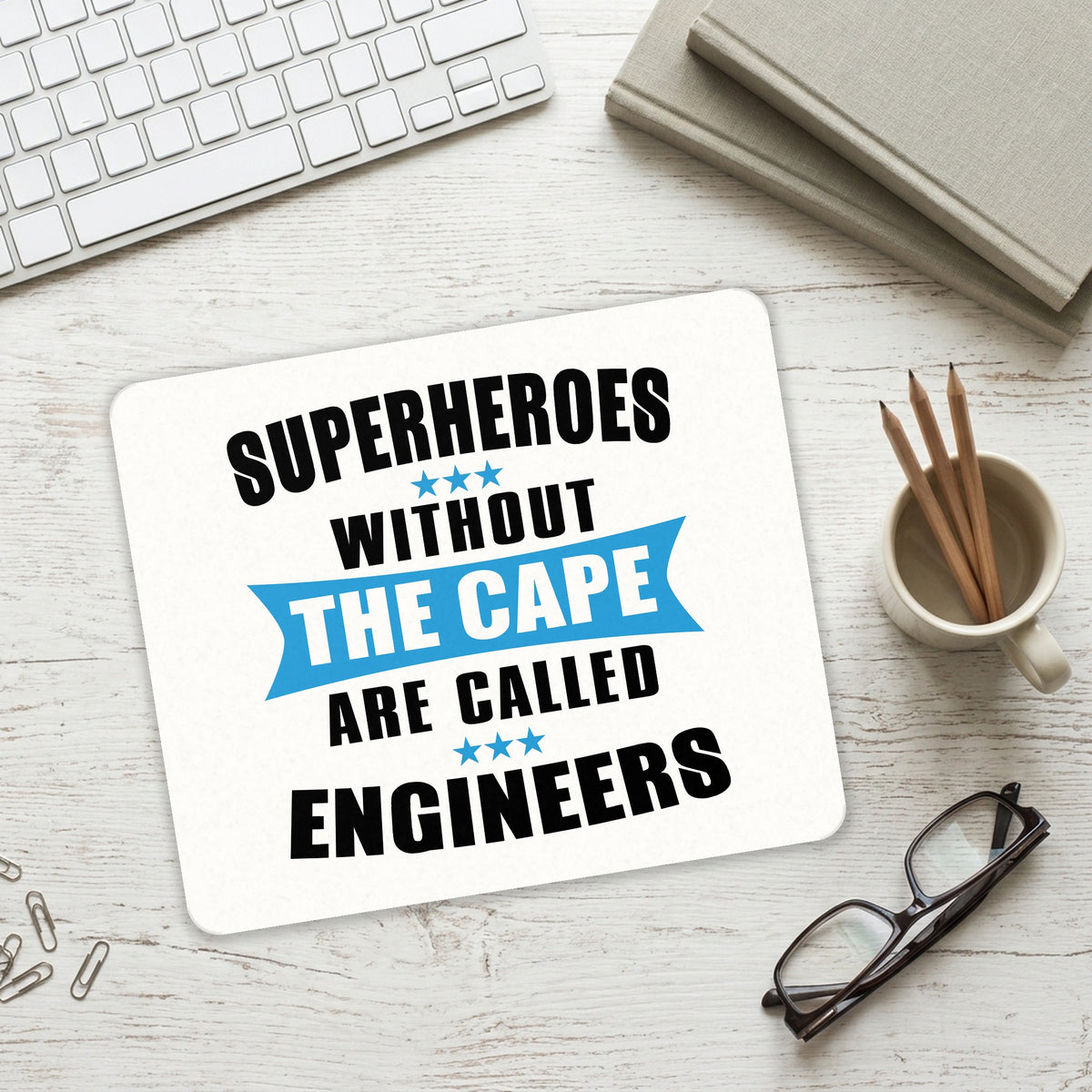 Superheroes Without Cape are Engineers mouse pad on a desk with a keyboard