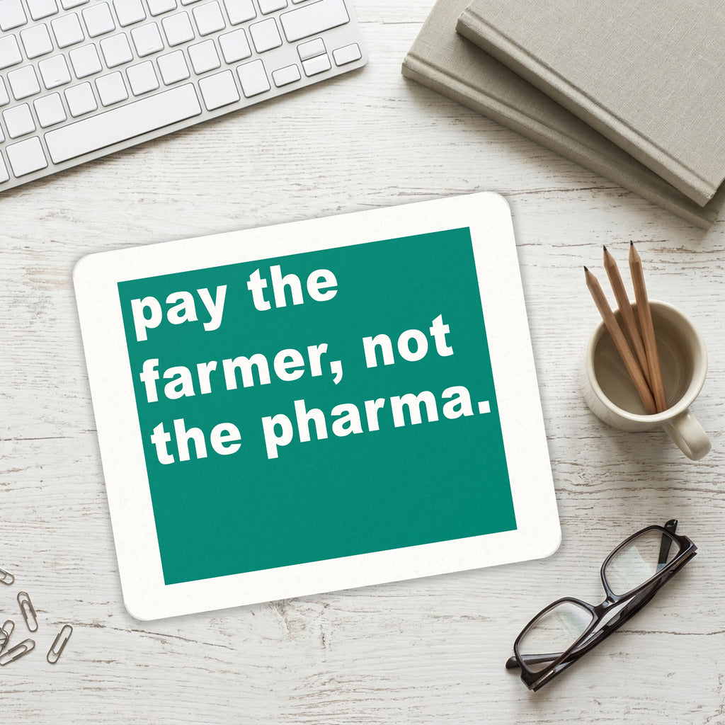 Pay the Farmer, Not the Pharma. mouse pad on a desk with a keyboard