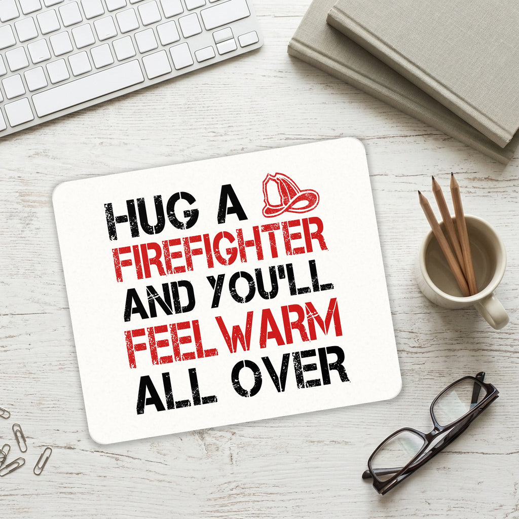 Hug a Firefighter You'll Feel Warm All Over mouse pad on a desk with a keyboard