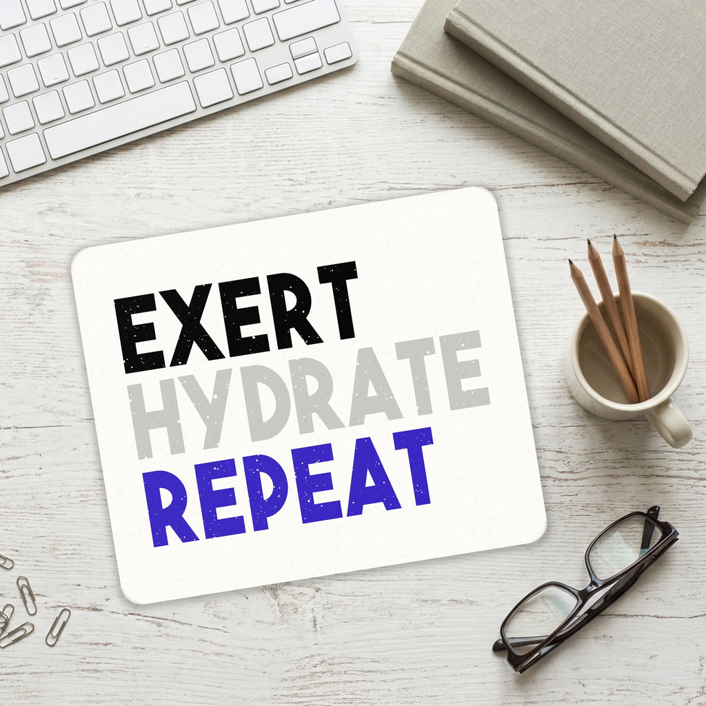 Exert Hydrate Repeat mouse pad on a desk with a keyboard