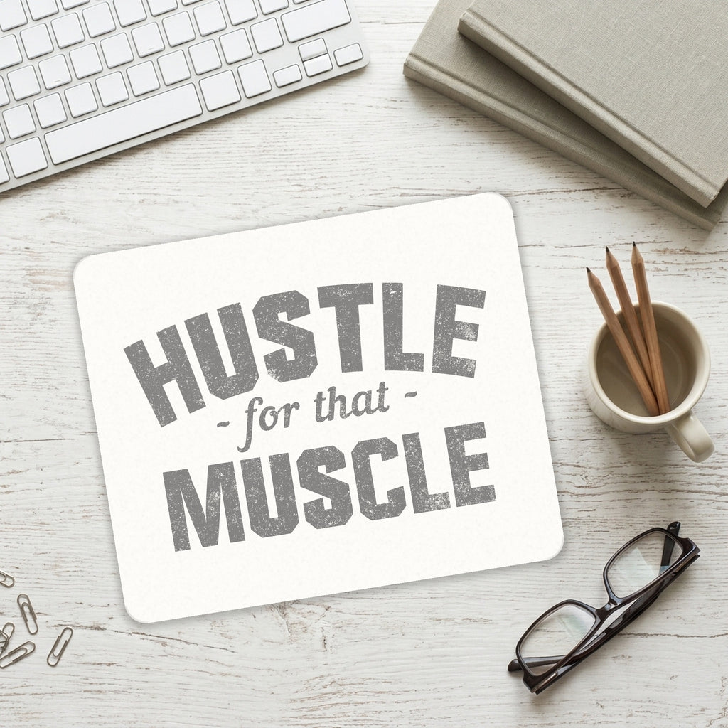 Hustle for that Muscle mouse pad on a desk with a keyboard