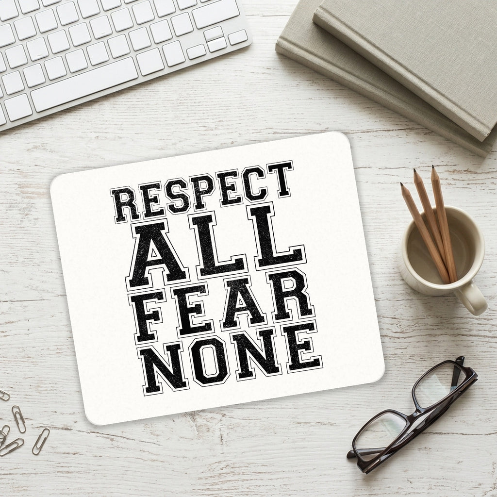 Respect All Fear None mouse pad on a desk with a keyboard