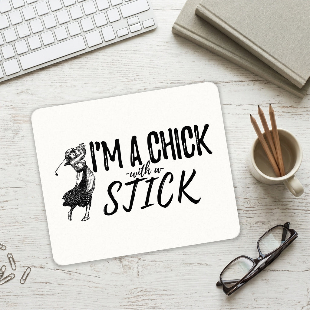 I'm a Chick with a Stick Golf mouse pad on a desk with a keyboard