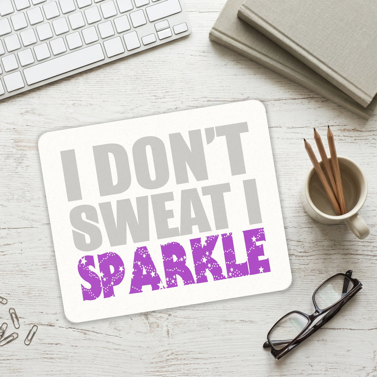 I Don't Sweat I Sparkle mouse pad on a desk with a keyboard