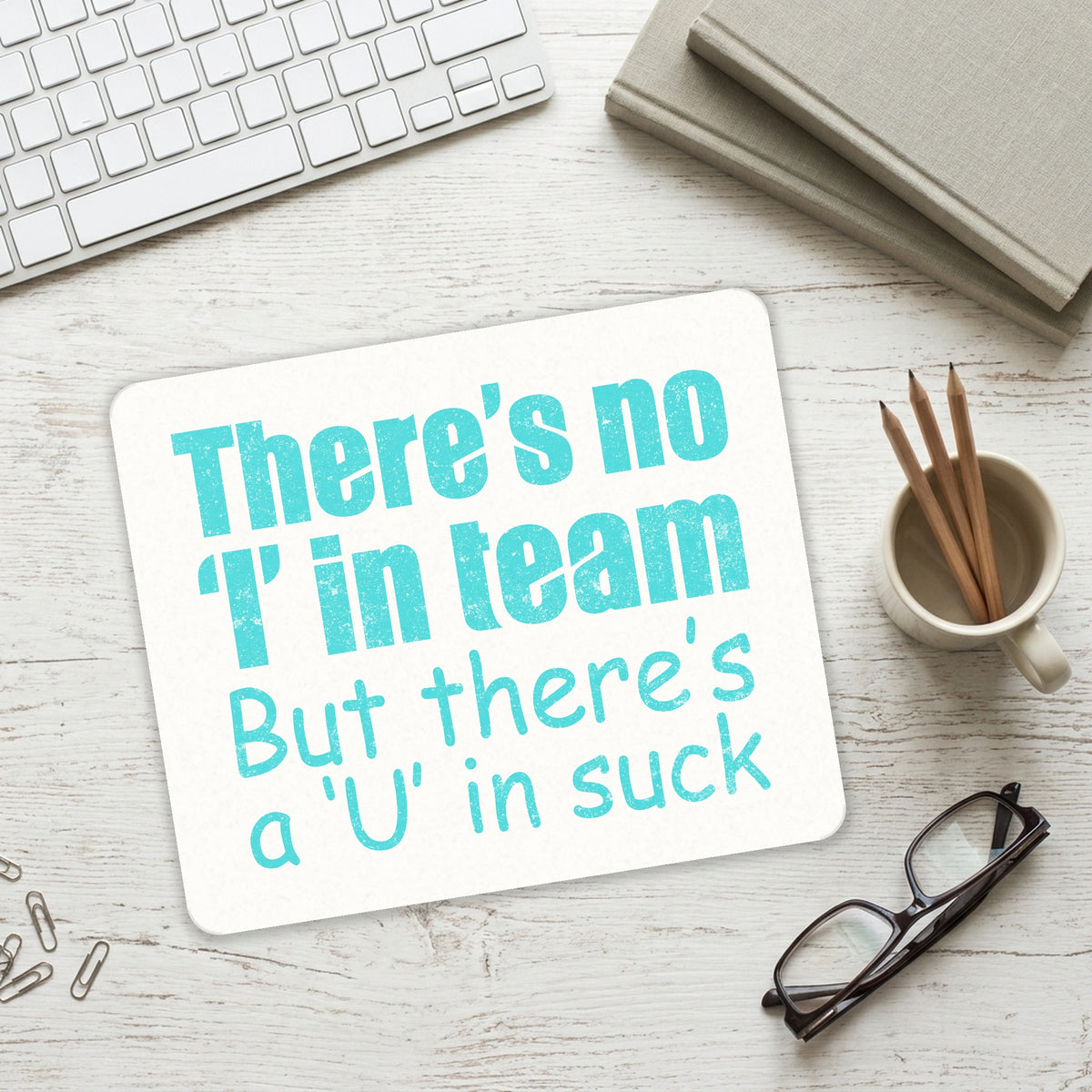 There's No I in Team There's a U in Suck mouse pad on a desk with a keyboard