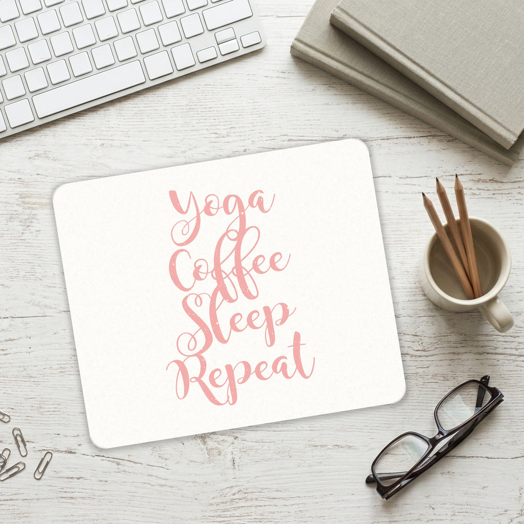 Yoga Coffee Sleep Repeat mouse pad on a desk with a keyboard