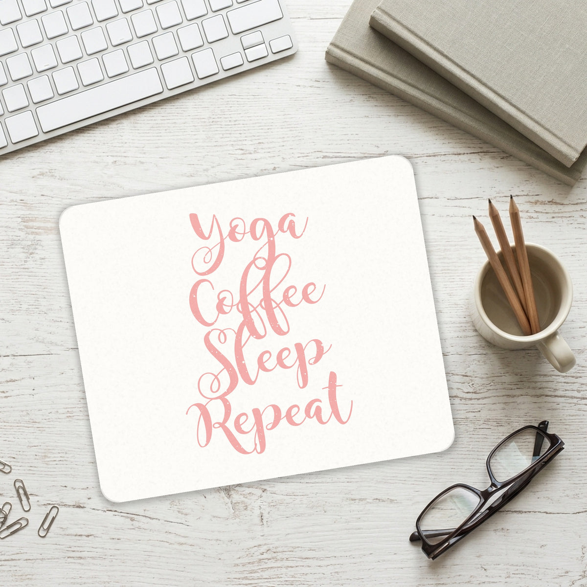 Yoga Coffee Sleep Repeat mouse pad on a desk with a keyboard