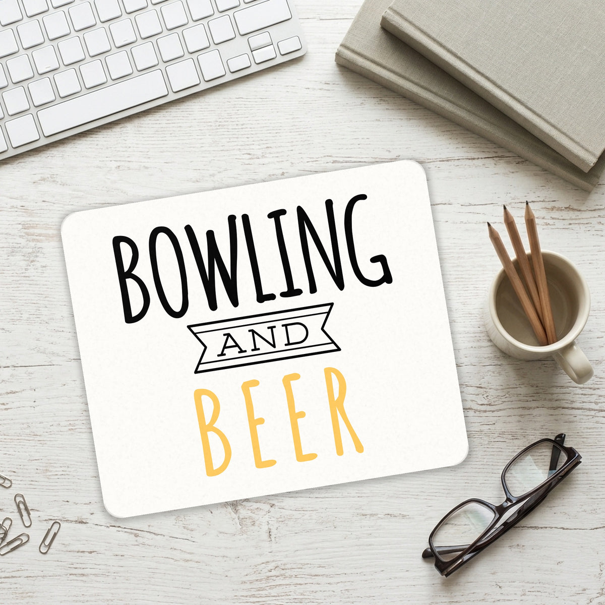 Bowling and Beer mouse pad on a desk with a keyboard