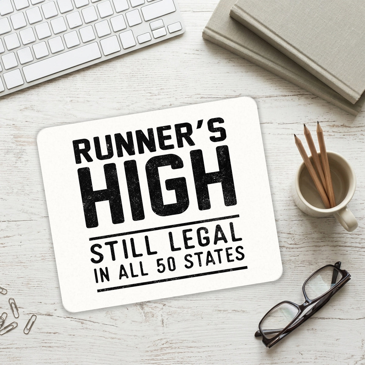 Runner's High Still Legal in All 50 States mouse pad on a desk with a keyboard