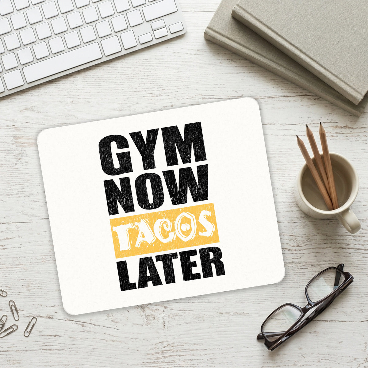 Gym Now Tacos Later mouse pad on a desk with a keyboard