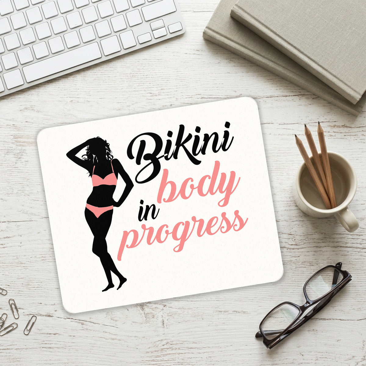 Bikini Body in Progress mouse pad on a desk with a keyboard