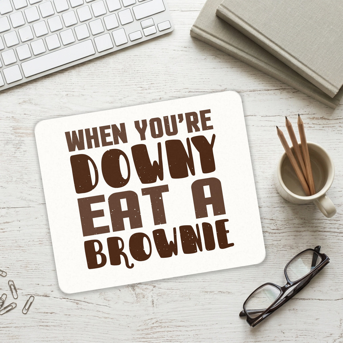 When You're Downy Eat a Brownie mouse pad on a desk with a keyboard