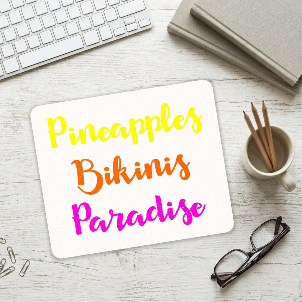 Pineapples Bikinis Paradise mouse pad on a desk with a keyboard