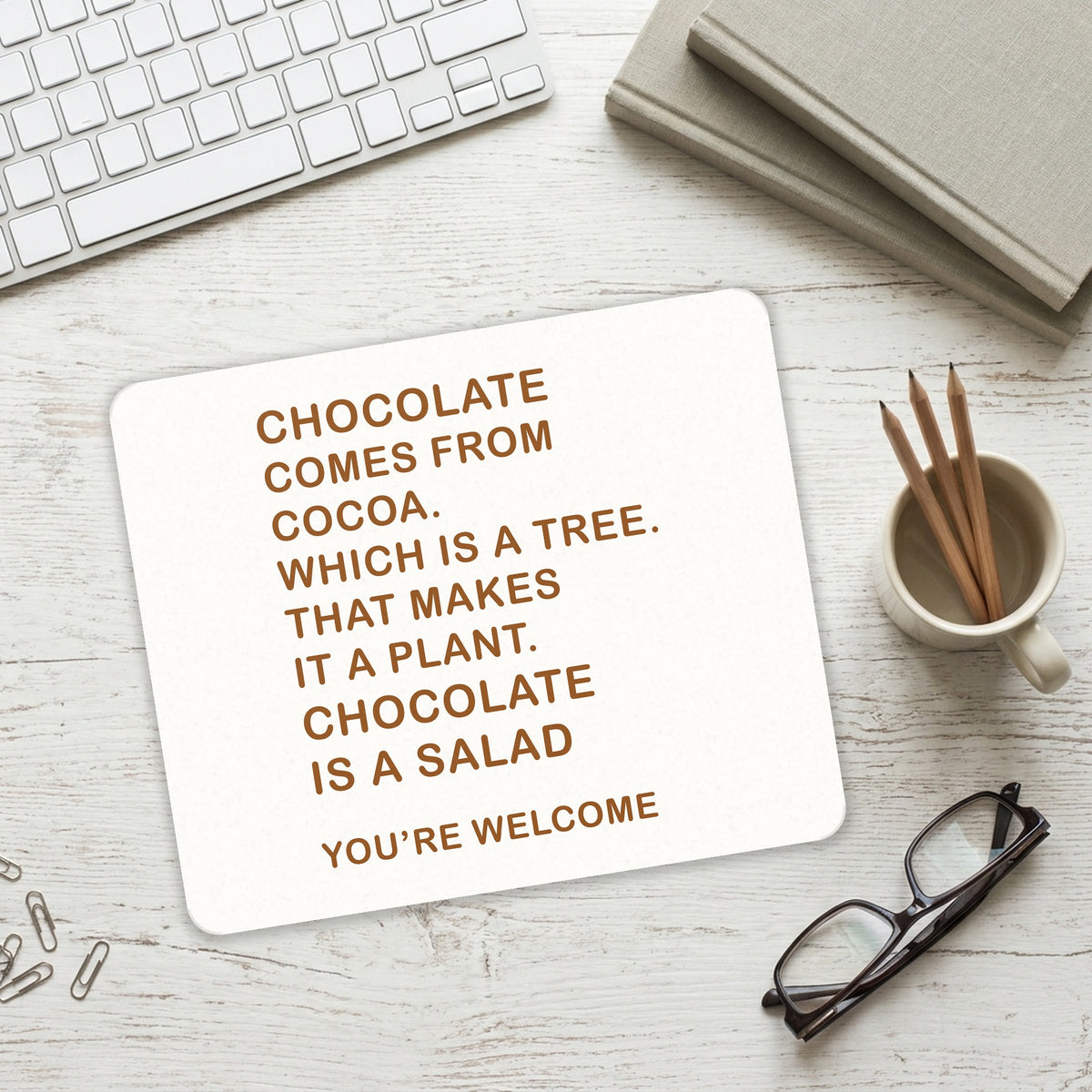 Chocolate Comes From Cocoa Is A Salad mouse pad on a desk with a keyboard