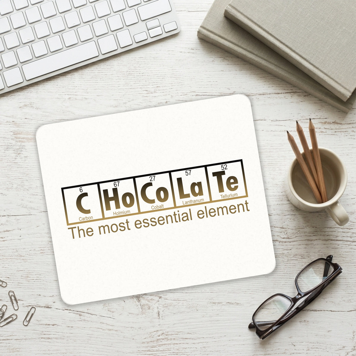 Chocolate The Most Essential Element mouse pad on a desk with a keyboard