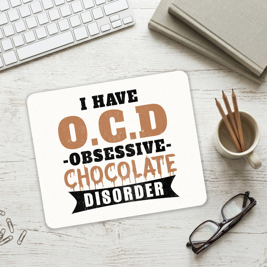 OCD Obsessive Chocolate Disorder mouse pad on a desk with a keyboard