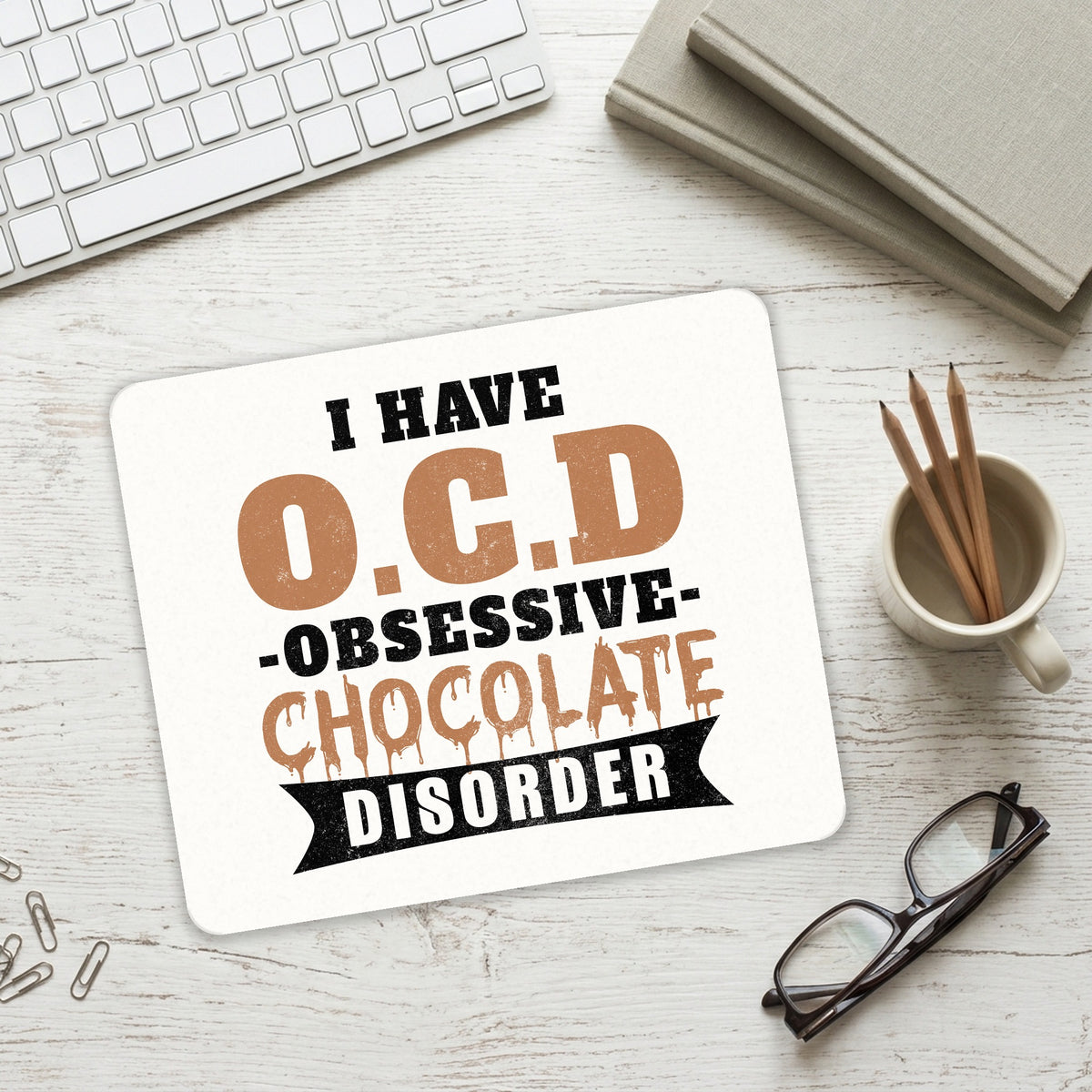 OCD Obsessive Chocolate Disorder mouse pad on a desk with a keyboard