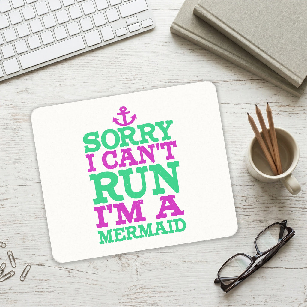 Sorry I Can't Run I'm a Mermaid mouse pad on a desk with a keyboard