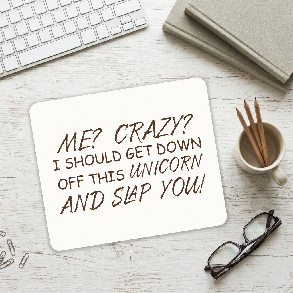 Me? Crazy? I Should Get Down Off This Unicorn mouse pad on a desk with a keyboard