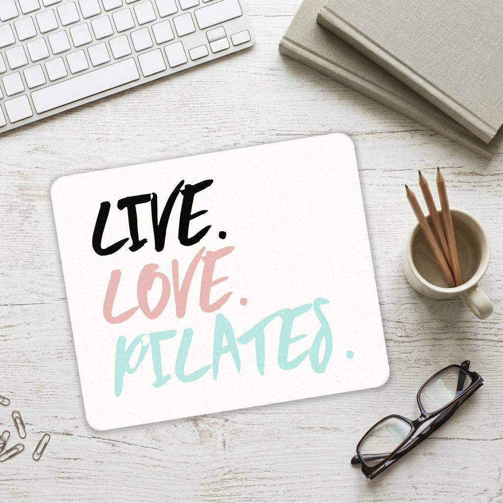 Live. Love. Pilates. mouse pad on a desk with a keyboard