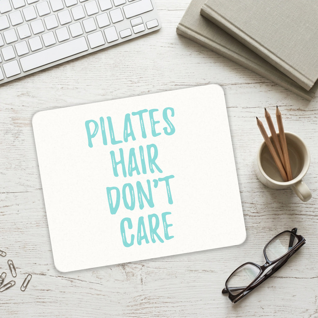 Pilates Hair Don't Care mouse pad on a desk with a keyboard