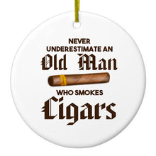 DistinctInk® Hanging Ceramic Christmas Tree Ornament with Gold String - Great Gift / Present - 2 3/4 inch Diameter - Never Underestimate Old Man Who Smokes Cigars