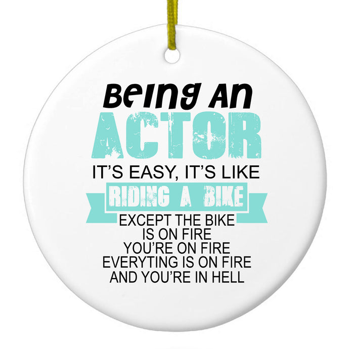 DistinctInk® Hanging Ceramic Christmas Tree Ornament with Gold String - Great Gift / Present - 2 3/4 inch Diameter - Being An Actor is Easy - It's Like Riding A Bike