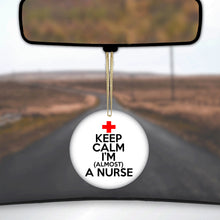 DistinctInk® Hanging Ceramic Christmas Tree Ornament with Gold String - Great Gift / Present - 2 3/4 inch Diameter - Keep Calm I'm Almost a Nurse