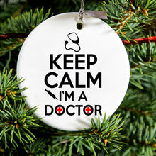 DistinctInk® Hanging Ceramic Christmas Tree Ornament with Gold String - Great Gift / Present - 2 3/4 inch Diameter - Keep Calm I'm A Doctor