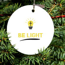 DistinctInk® Hanging Ceramic Christmas Tree Ornament with Gold String - Great Gift / Present - 2 3/4 inch Diameter - BE LIGHT - Cross in a Light Bulb